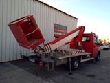 a red truck that is parked in front of a building