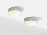 two light fixtures on the ceiling of a room with white walls