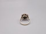 a close up of a gold ring with a black stone
