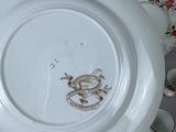a white plate with a dragon on it sitting on a table