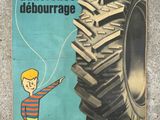 a poster of a man pointing to a giant tire