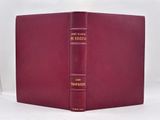 a red leather book with a gold trim and a red cover