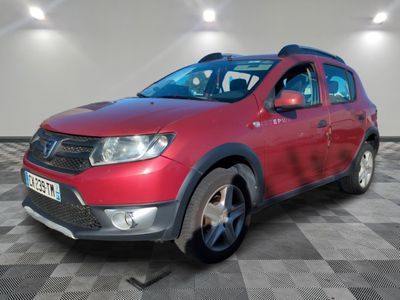 la voiture rouge est garée sur un sol en damier dans le garage
