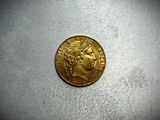a gold coin with a woman ' s head on it