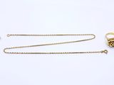 a collection of gold jewellery including a ring and a chain