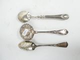 three silver spoons and two silver spoons on a white surface