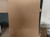 a cardboard box with a bow on it sitting on the floor