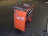 an orange tool cart with tools on it in a warehouse