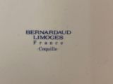 a close up of a white plate with blue writing on it