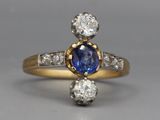 a close up of a diamond and sapphire ring on a table