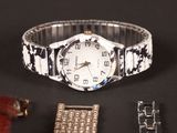 a watch and a bracelet on a black surface