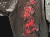 an image of a black jacket with a red dragon on the back