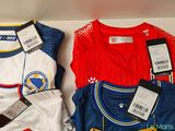 three shirts that are on display in a box