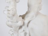 statue of a woman holding a flower in her hand