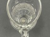 a clear glass cup with a handle on a table