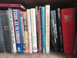 many books that are on a shelf in the room