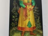an image of a small tin box with a painting of a man in a yellow coat