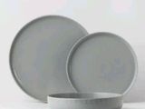 two plates and a bowl sitting on a table