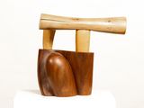 a wooden object that is on top of a white cake