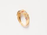 a close up of a gold ring with multi colored stones