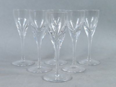 six clear wine glasses sitting on top of a white table