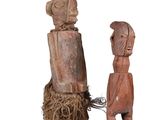 wooden figurines of a man and a woman holding hands
