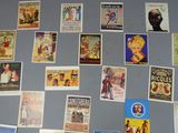 a refrigerator covered with posters and magnets on the wall
