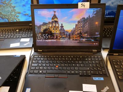several laptops are on display on a table with price tags
