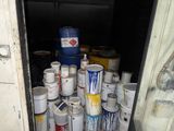 many cans of paint and cans of paint in the back of a truck