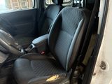 the interior of a van with black seats and a steering wheel