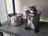 two pots and a blender on a shelf in a kitchen