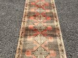 an old runner rug is laying on the pavement