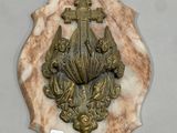 a plaque with a cross on it on a wall