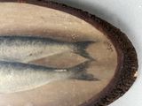 a picture of two fish that are on a wood slice
