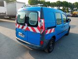 a blue van with red and white stripes parked in a parking lot