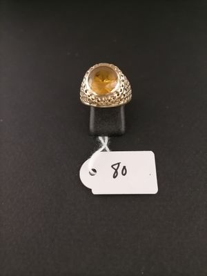 a close up of a ring with a tag on a table