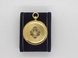 a close up of a small gold locke with a picture on it