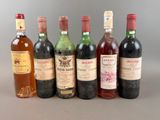 several bottles of wine are lined up in a row