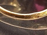 a close up of a gold ring with a heart on it