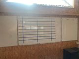 a white board on the wall in a room