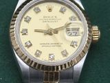 an image of a gold and silver watch with diamonds on the face