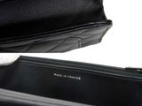a black purse that is open on a white surface