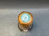 a close up of a beer bottle cap on a sink