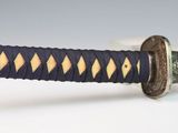 a close up of a sword with a blue handle