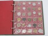 a red book with a bunch of coins inside of it