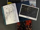 three books on a table, one of which has a drawing of a woman and the other of which is a drawing of a man