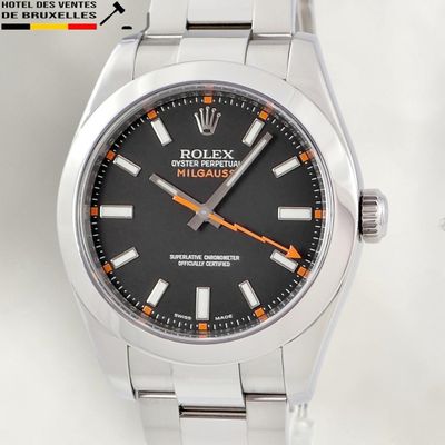 a close up of a watch with a black dial