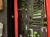 a close up of a red metal cabinet with tools in it