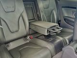 the interior of a car with leather seats and a tray in the back