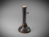 a small candle holder with a candle on top of it